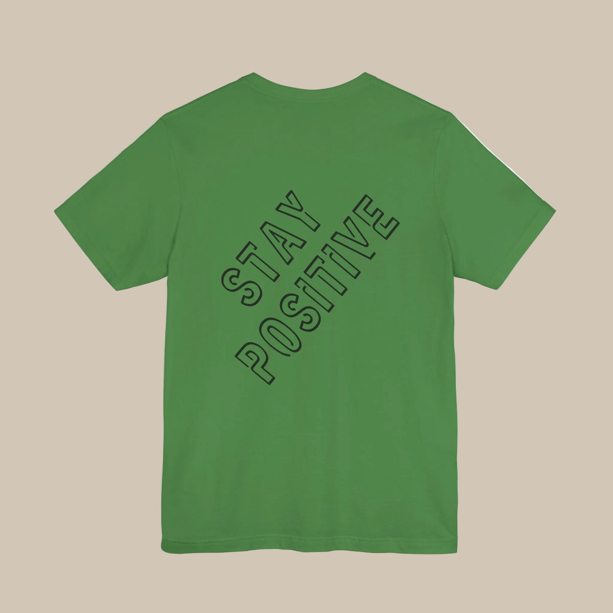 Green t-shirt with 'Stay Positive' backprint text on the back against a green background