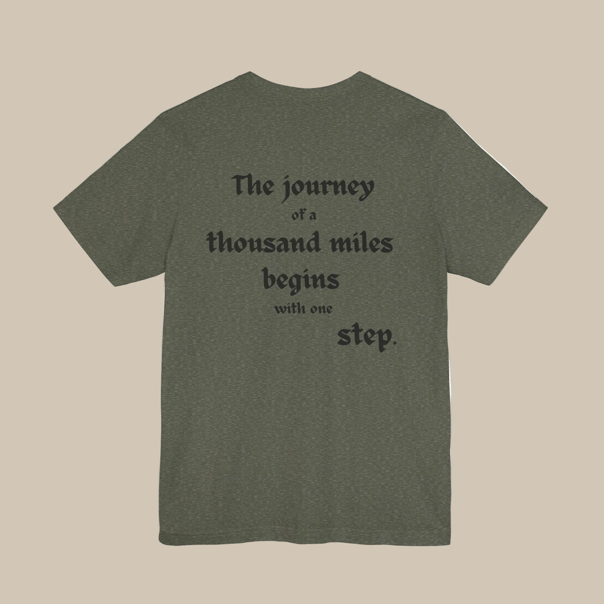 Green t-shirt with black text backprint on a green background