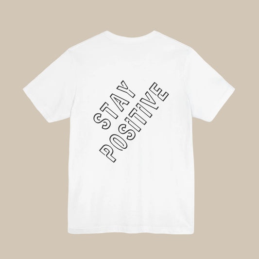 White t-shirt with 'Stay Positive' backprint text on a white background
