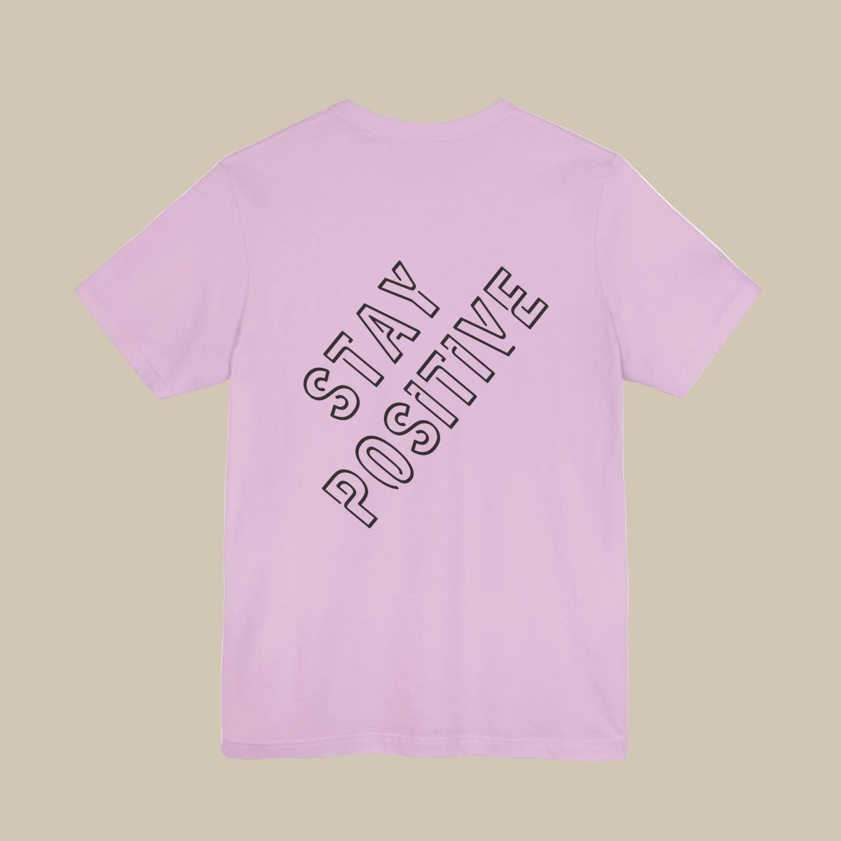 Pink t-shirt with 'Stay Positive' backprint text on a pink background