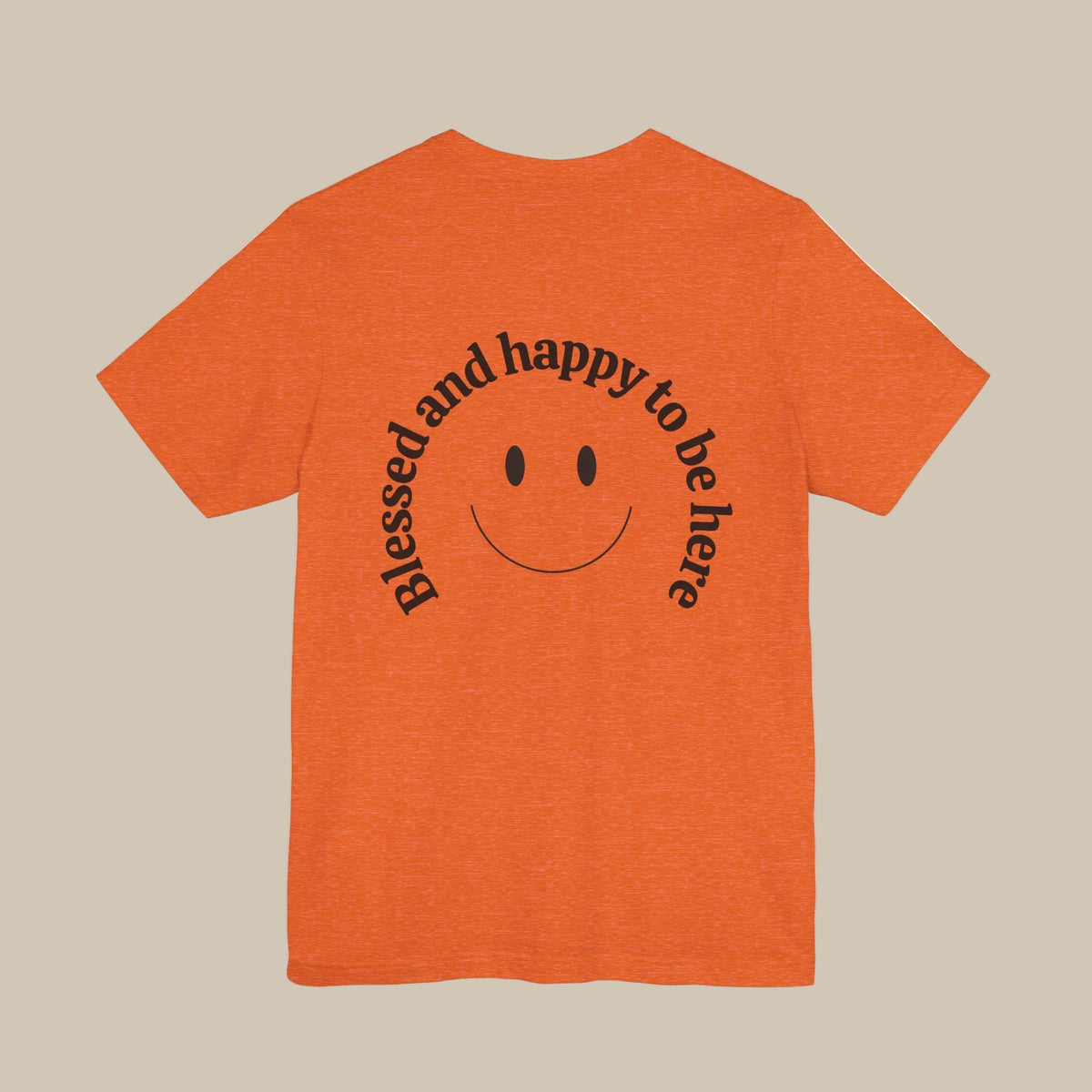 Orange t-shirt with a smiley face and text on the back against a orange background