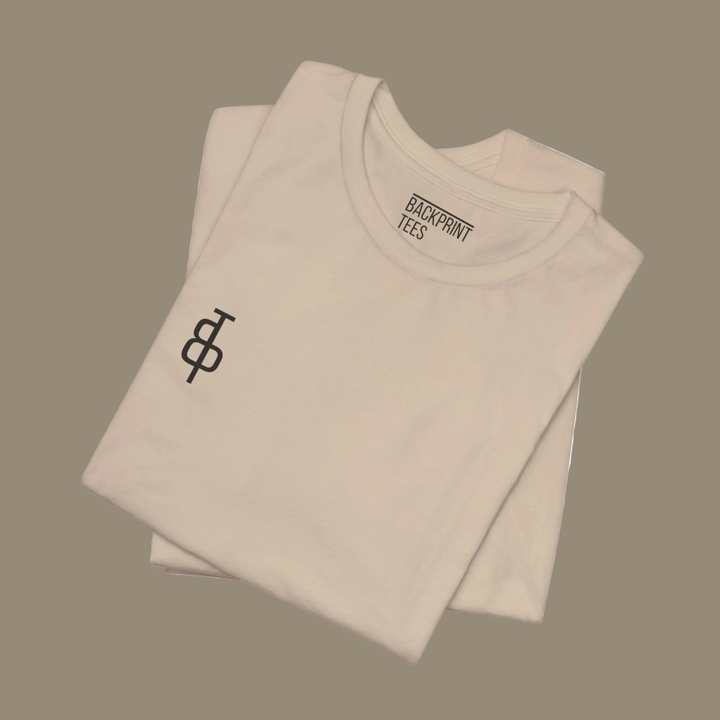 Folded beige gym t-shirt with a logo and 'Backprint Tees' text on a beige background