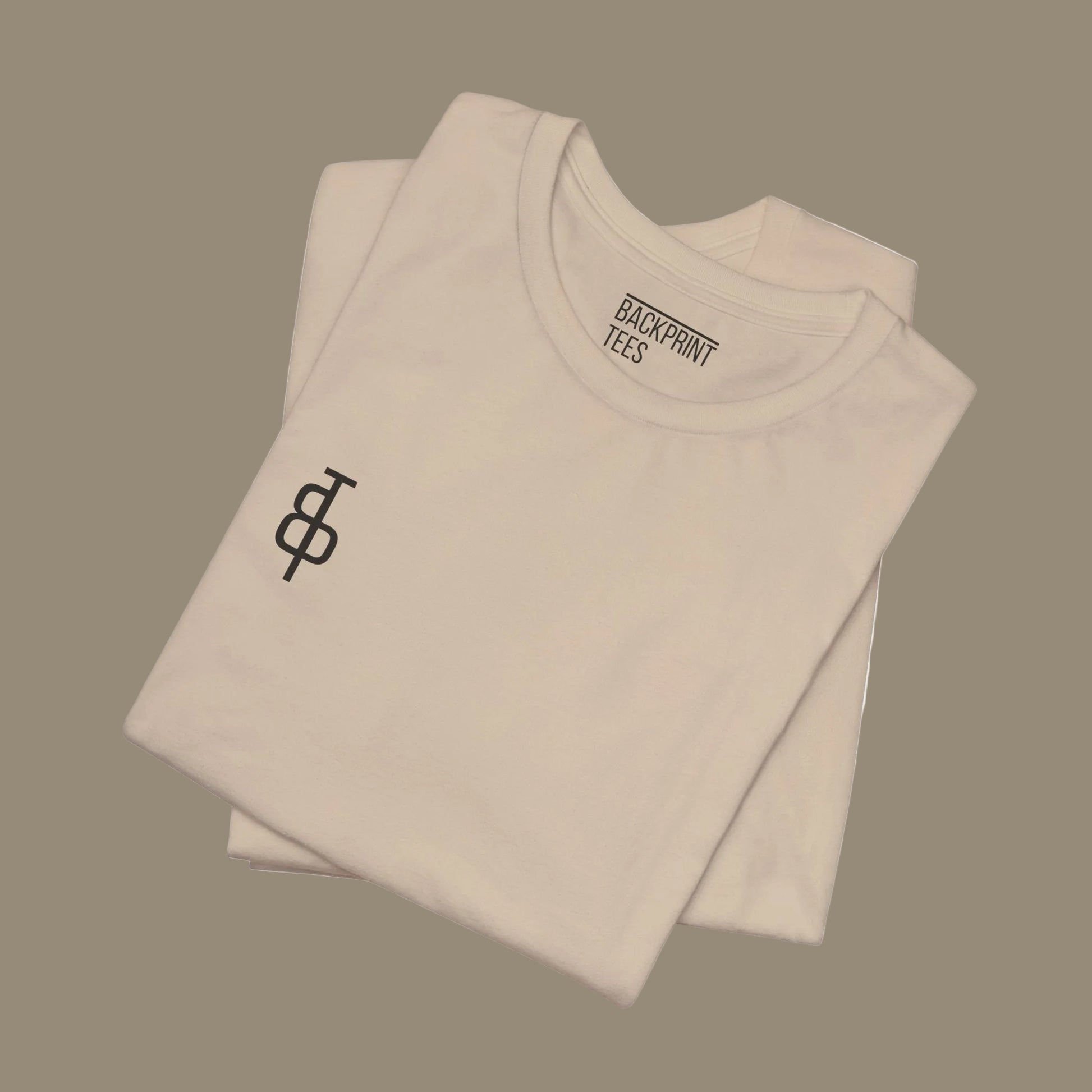 Folded beige gym t-shirt with a logo and 'Backprint Tees' text on a beige background