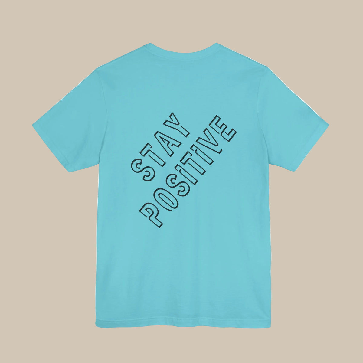 Light blue t-shirt with 'Stay Positive' backprint text against a light blue background