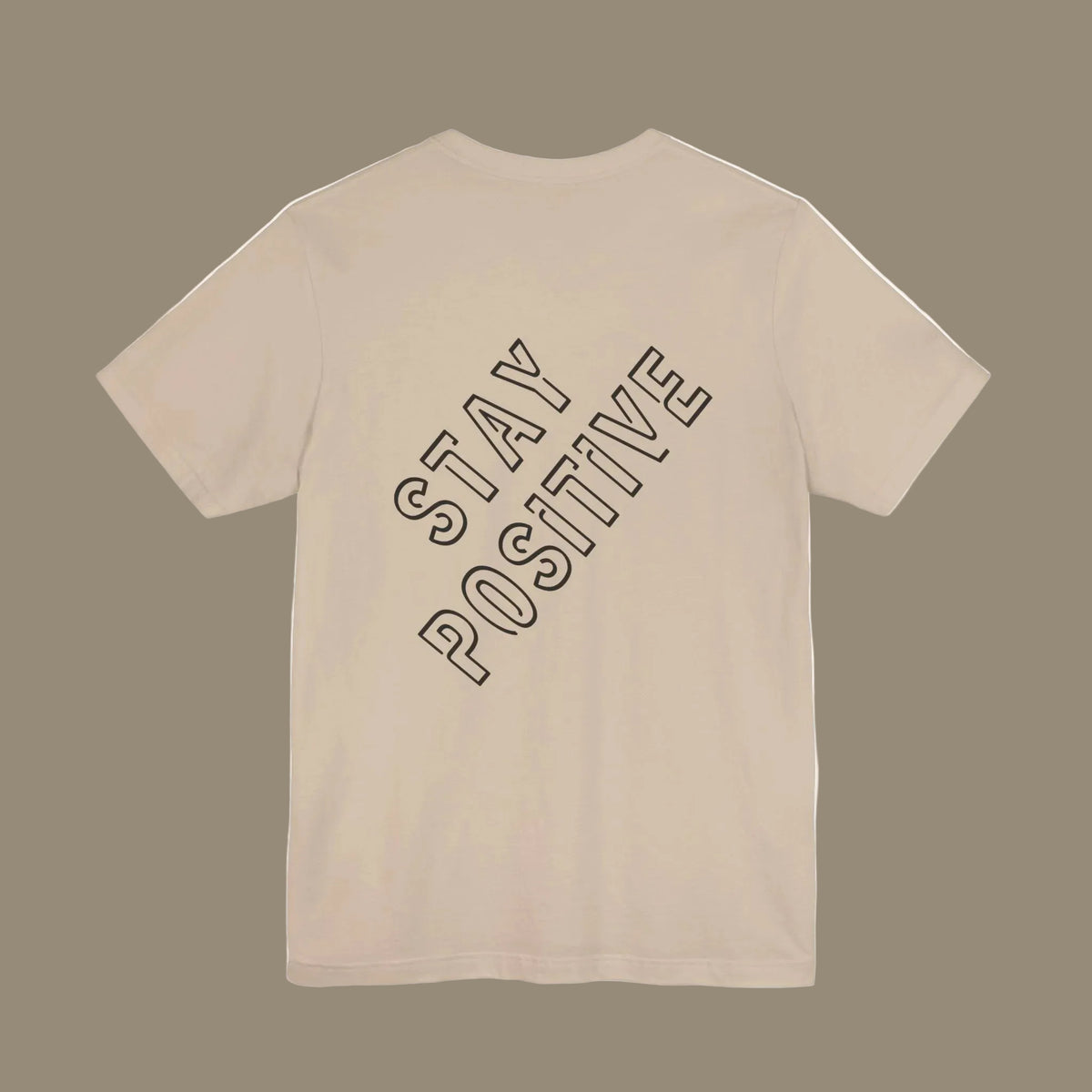 Beige t-shirt with 'Stay Positive'backprint  text on a beige background