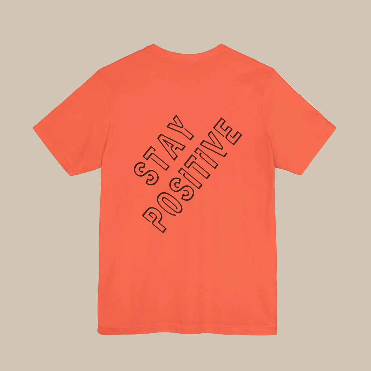 Orange t-shirt with 'Stay Positive' backprint text on the back against a orange background