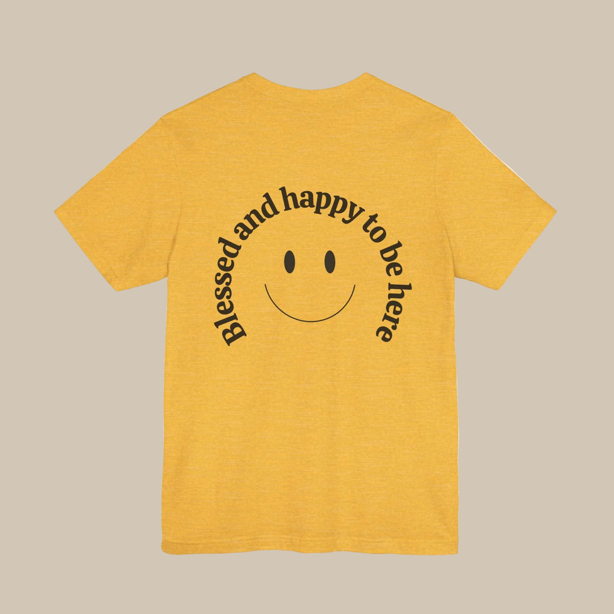 Yellow t-shirt with a smiley face and text on the back against a yellow background