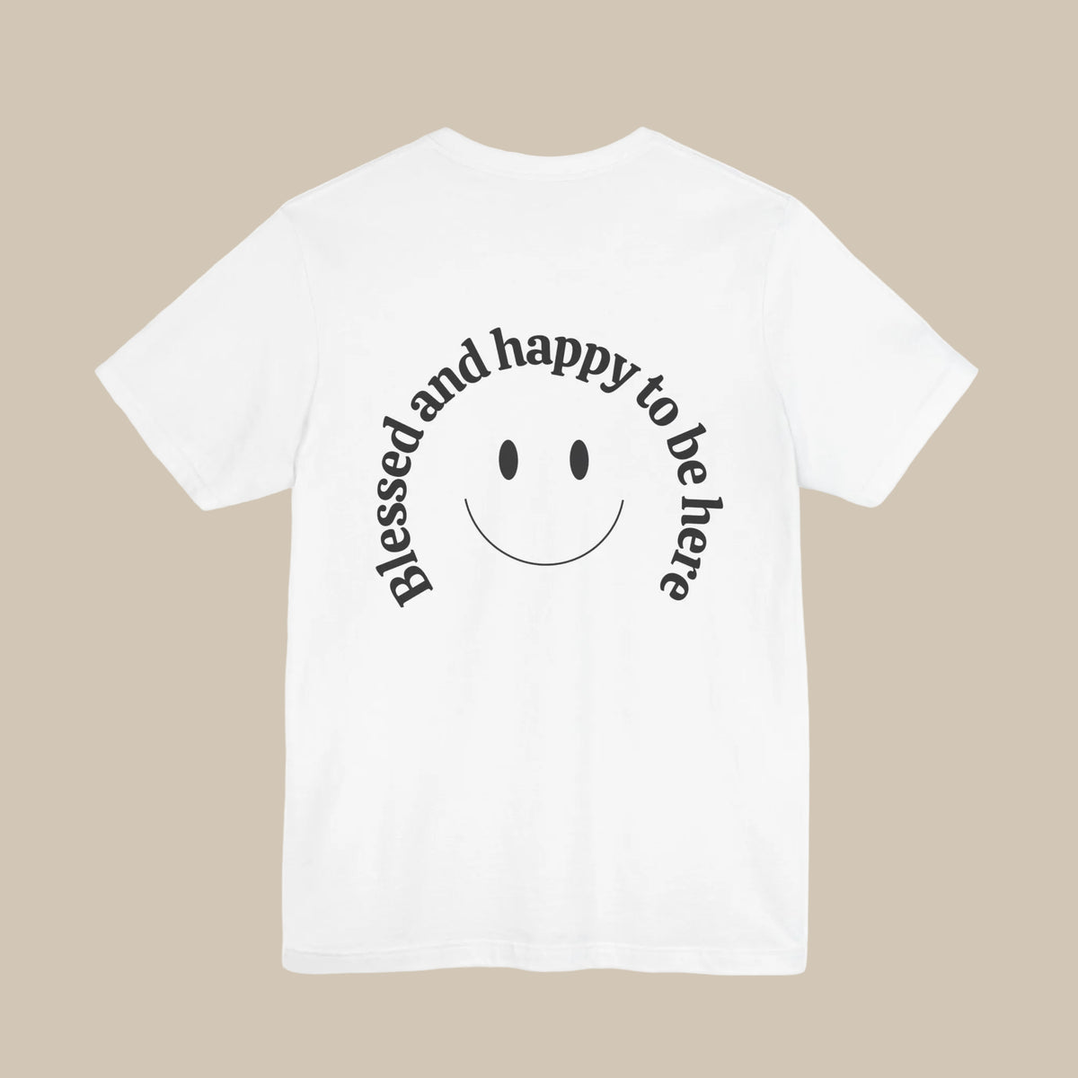 White t-shirt with a smiley face and text 'Blessed and happy to be here' on a white background